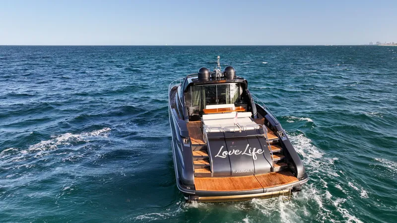 Love Life Yacht Photos Pics Luxury yacht Riva 68' EGO SUPER 2009 cruising on open sea, rear view.