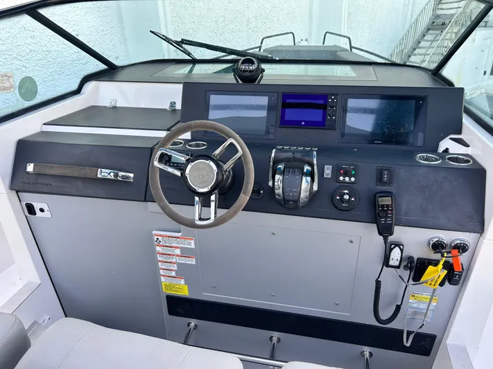  Yacht Photos Pics 2019 Axopar 37 Sun Top helm with modern controls and navigation displays.