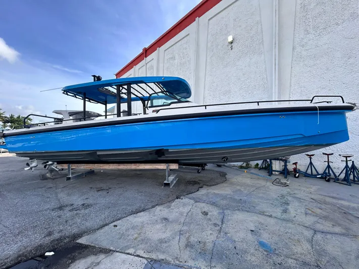  Yacht Photos Pics 2019 Axopar 37 Sun Top boat in vibrant blue, displayed outdoors.