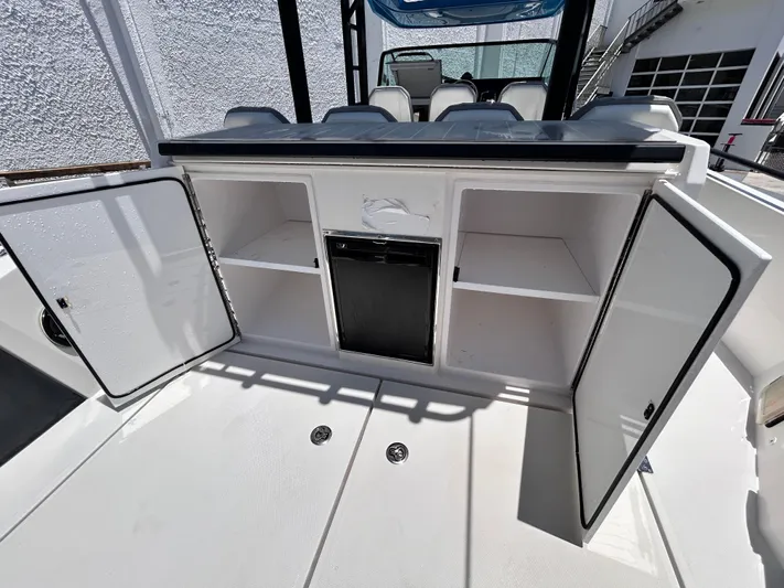  Yacht Photos Pics 2019 Axopar 37 Sun Top boat interior storage compartments with open doors.
