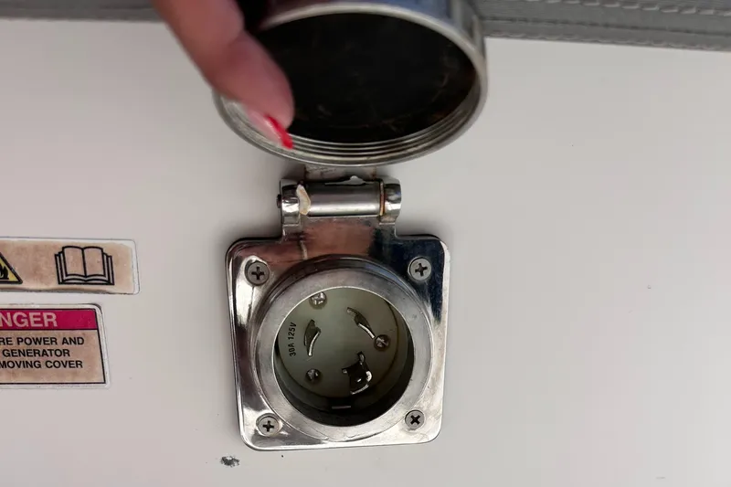  Yacht Photos Pics Power socket on 2019 Axopar 37 Sun Top boat with safety warning label.