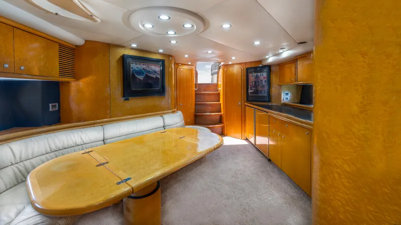  Yacht Photos Pics Luxurious interior of 1999 Sunseeker Predator 58 yacht with elegant wood finishes and modern lighting.