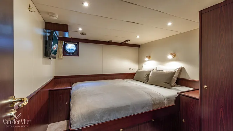  Yacht Photos Pics Luxurious cabin interior of 2009 Altena Trawler with cozy bed and elegant wood finish.