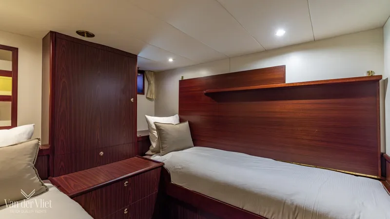  Yacht Photos Pics Cozy cabin interior of 2009 Altena Trawler with twin beds and wooden furnishings.