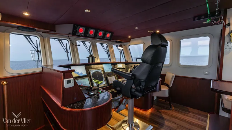  Yacht Photos Pics Pilothouse interior of 2009 Altena Trawler with modern navigation equipment and captain's chair.