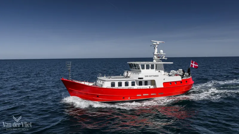  Yacht Photos Pics Red Altena Trawler 2009 cruising on open sea under clear blue sky.