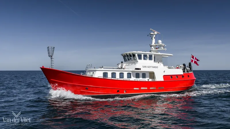  Yacht Photos Pics Red Altena Trawler 2009 cruising on open sea under clear blue sky.