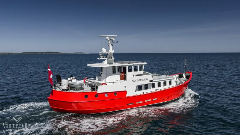  Yacht Photos Pics Red Altena Trawler 2009 cruising on open sea under clear blue sky.