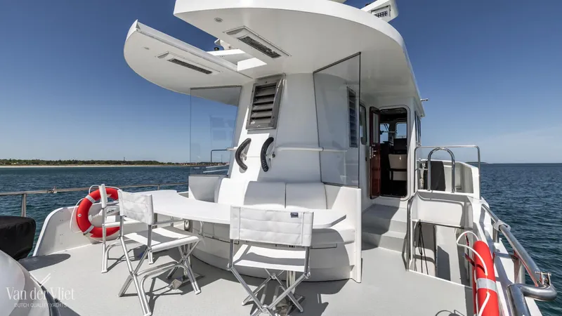  Yacht Photos Pics Altena Trawler 2009 yacht with outdoor seating, life rings, and ocean view.