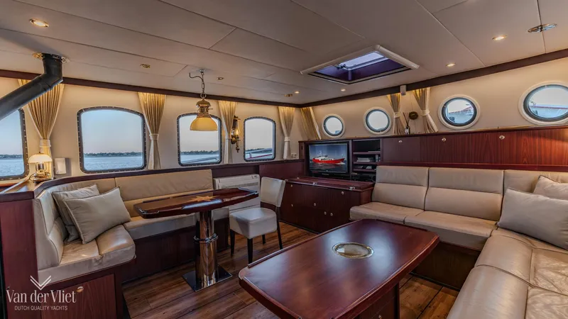  Yacht Photos Pics Luxurious interior of 2009 Altena Trawler with elegant seating and nautical decor.