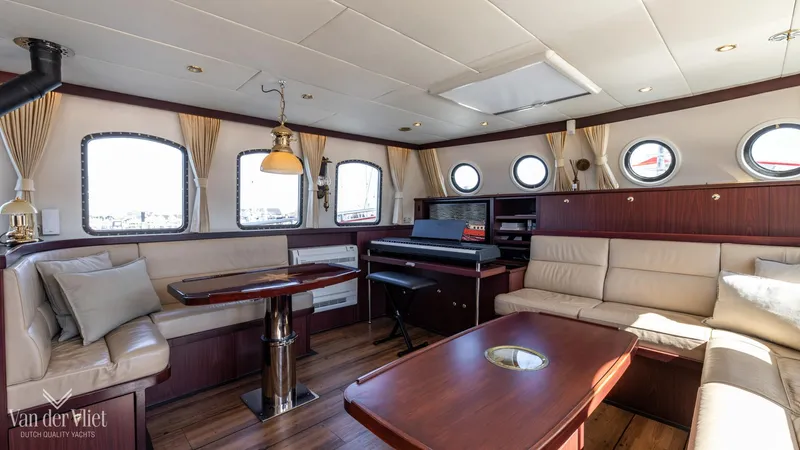  Yacht Photos Pics Luxurious 2009 Altena Trawler interior with elegant seating, wooden accents, and natural light.