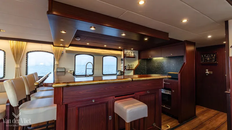  Yacht Photos Pics Luxurious interior of 2009 Altena Trawler yacht with elegant wood finishes and modern amenities.