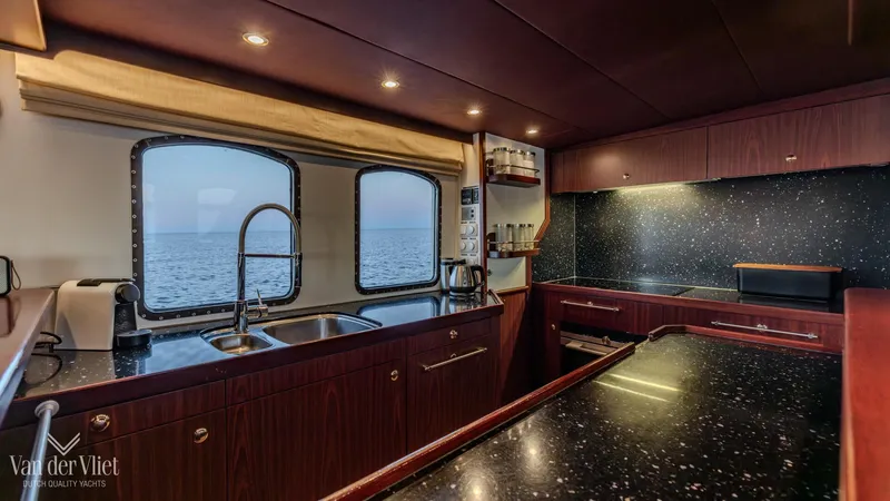  Yacht Photos Pics Luxurious 2009 Altena Trawler kitchen with ocean view, featuring sleek countertops and modern appliances.