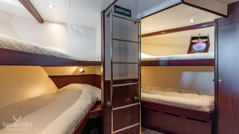 Yacht Photos Pics Interior of 2009 Altena Trawler, featuring cozy bunk beds and wooden finishes.