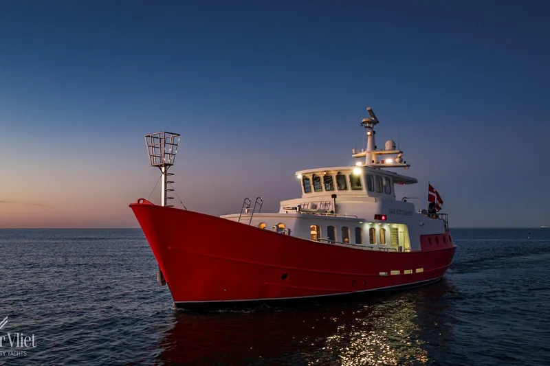  Yacht Photos Pics Red Altena Trawler yacht, 2009 model, sailing at sunset on calm waters.