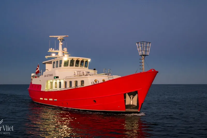  Yacht Photos Pics Red 2009 Altena Trawler yacht cruising on calm waters at dusk.