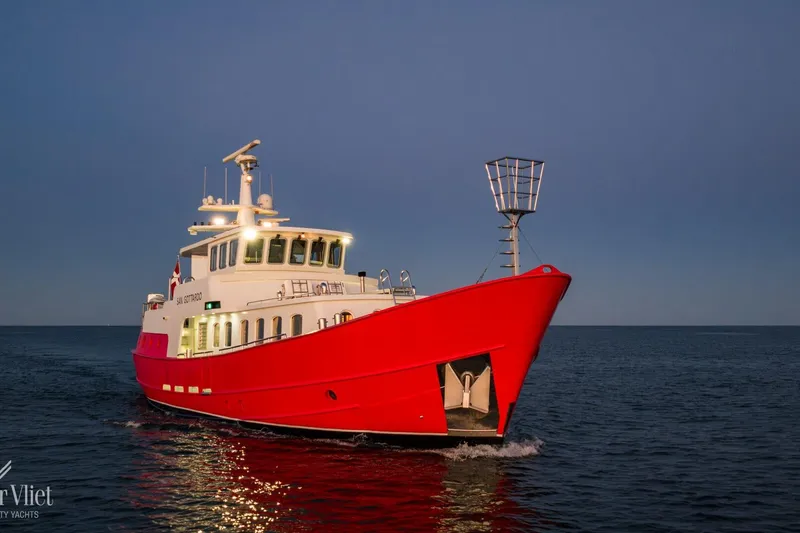  Yacht Photos Pics Red Altena Trawler yacht from 2009 sailing on calm waters at dusk.