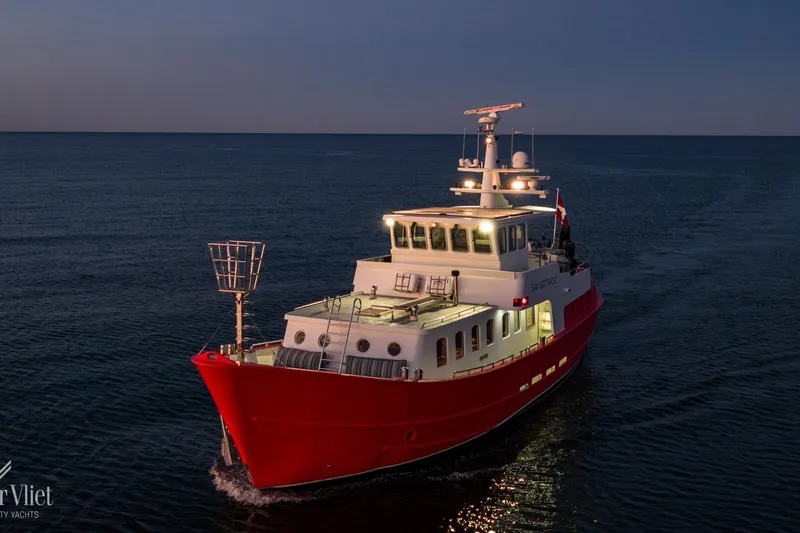  Yacht Photos Pics Red Altena Trawler yacht cruising at dusk, 2009 model, on open sea.