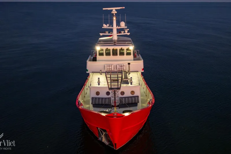  Yacht Photos Pics Red Altena Trawler yacht, 2009 model, illuminated on calm waters at dusk.