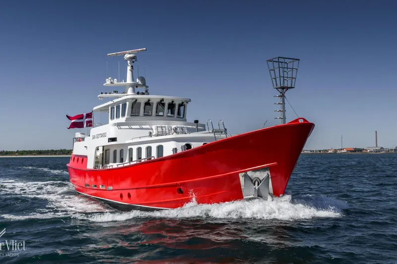  Yacht Photos Pics Red 2009 Altena Trawler cruising on open water under clear blue sky.