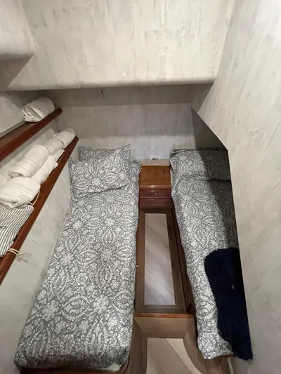 Play Pen Yacht Photos Pics 2001 Bertram 510 Convertible cabin with twin beds and patterned bedding.