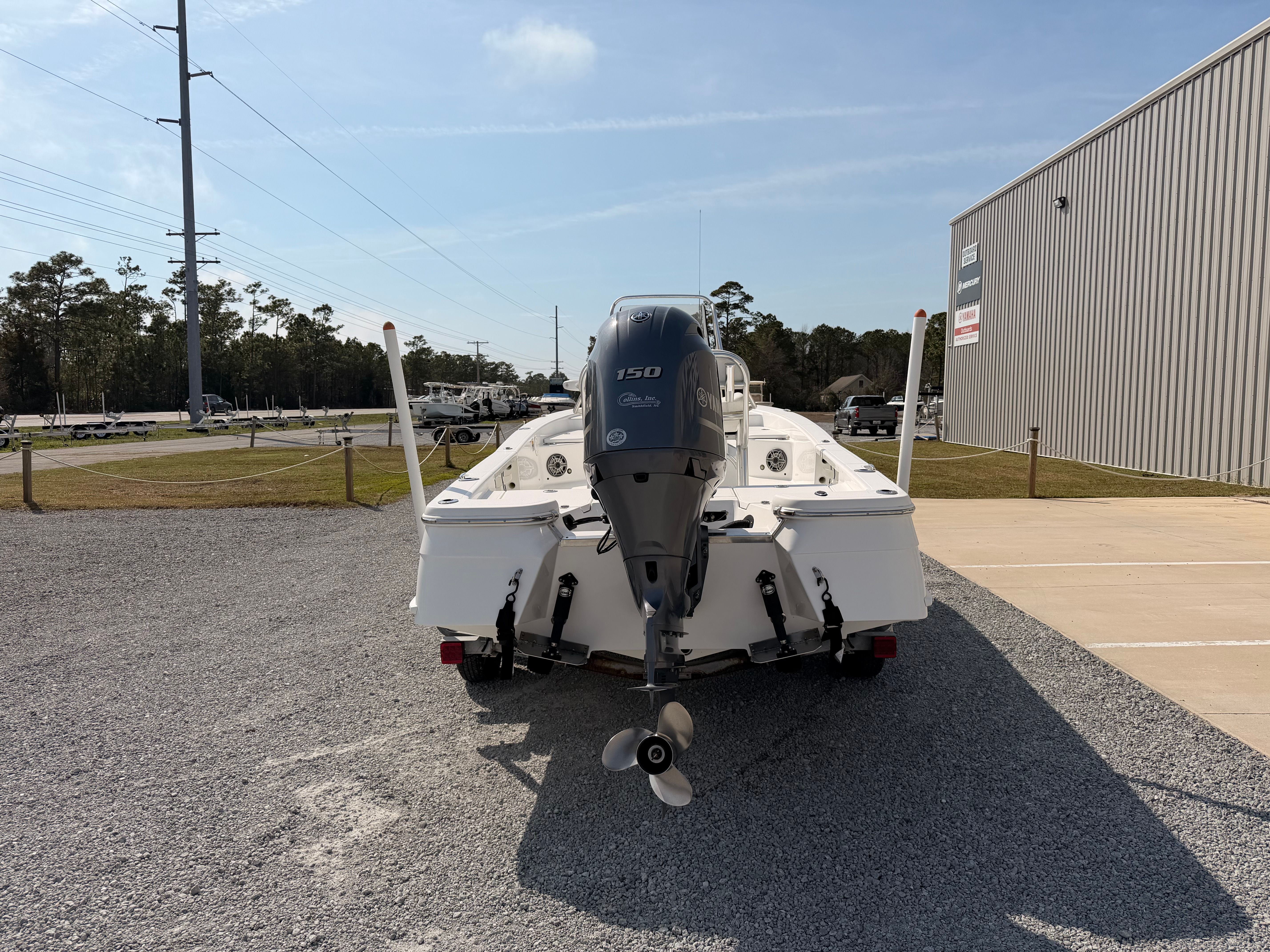 Rear view of a 2019 BlackJack 224 boat with outboard motor.