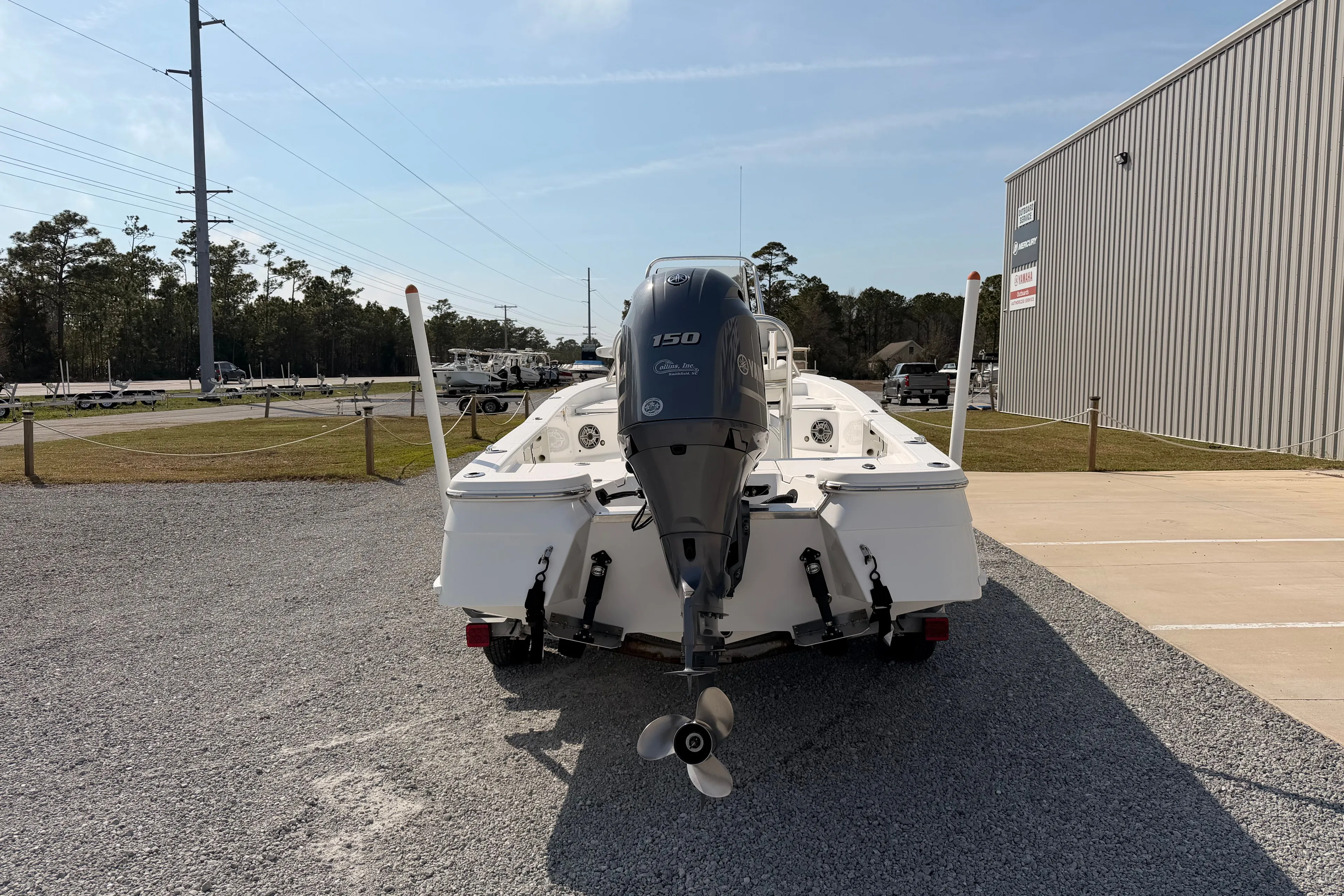 Rear view of a 2019 BlackJack 224 boat with outboard motor.