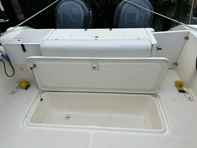  Yacht Photos Pics 2003 Pursuit 3070 Express boat with open storage compartment and dual outboard motors.