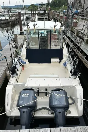  Yacht Photos Pics 2003 Pursuit 3070 Express boat with twin 225 engines docked at marina.