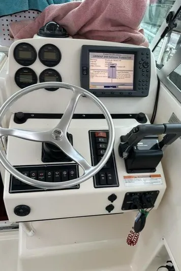  Yacht Photos Pics 2003 Pursuit 3070 Express boat dashboard with steering wheel, gauges, and navigation system.
