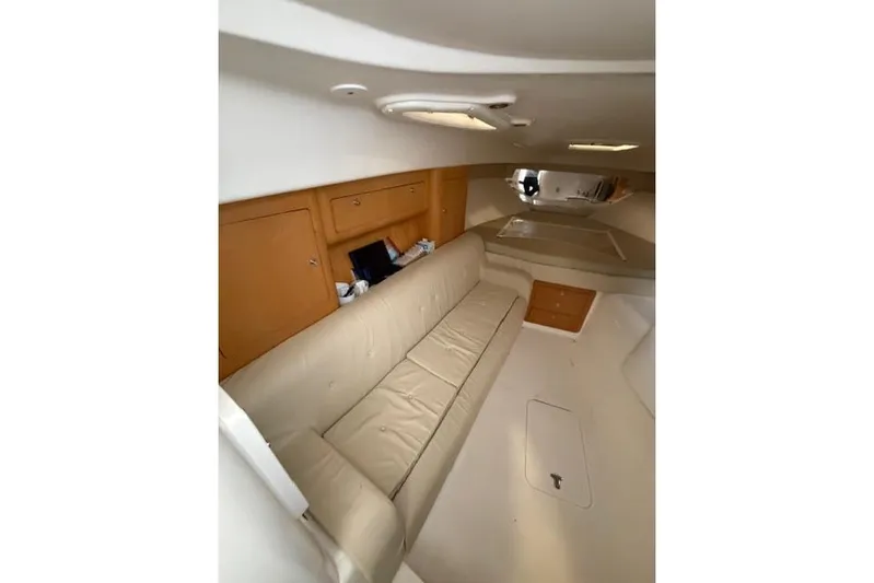  Yacht Photos Pics Interior of 2009 Intrepid 377 Walkaround with beige seating and wooden cabinets.