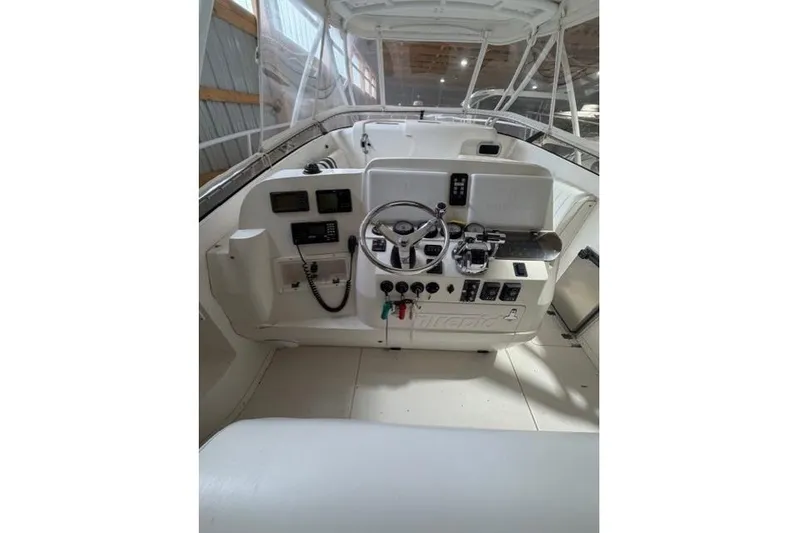  Yacht Photos Pics 2009 Intrepid 377 Walkaround boat helm with steering wheel and control panel.