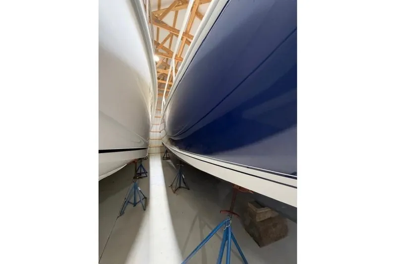  Yacht Photos Pics 2009 Intrepid 377 Walkaround boats in storage, blue and white hulls visible.