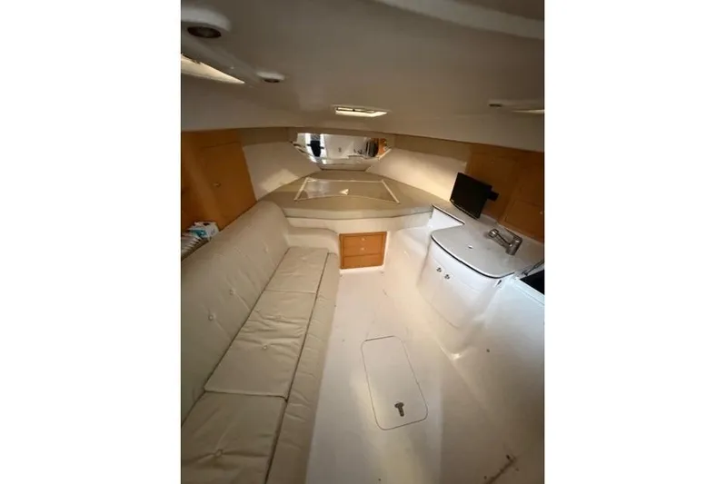  Yacht Photos Pics Interior of 2009 Intrepid 377 Walkaround boat with seating and compact kitchen area.