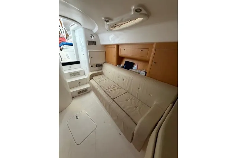  Yacht Photos Pics 2009 Intrepid 377 Walkaround interior with beige seating and wooden cabinetry.