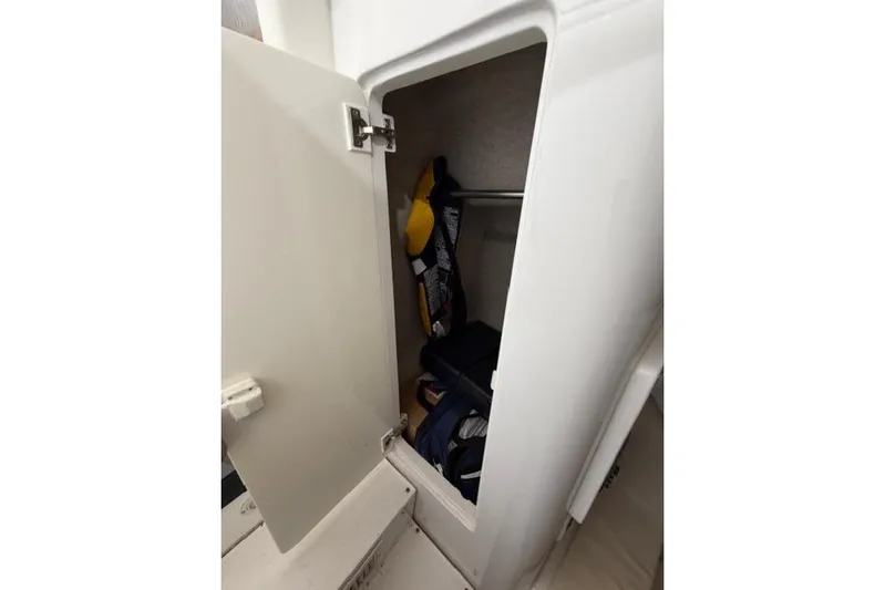  Yacht Photos Pics Open storage compartment on 2009 Intrepid 377 Walkaround boat, containing life jackets and gear.