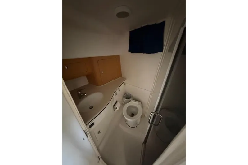  Yacht Photos Pics Bathroom interior of 2009 Intrepid 377 Walkaround boat, featuring sink and toilet.