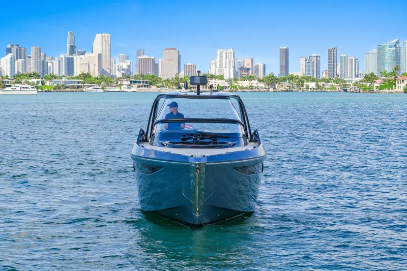 Mischief Yacht Photos Pics 2020 Princess R35 yacht cruising near city skyline on a sunny day.