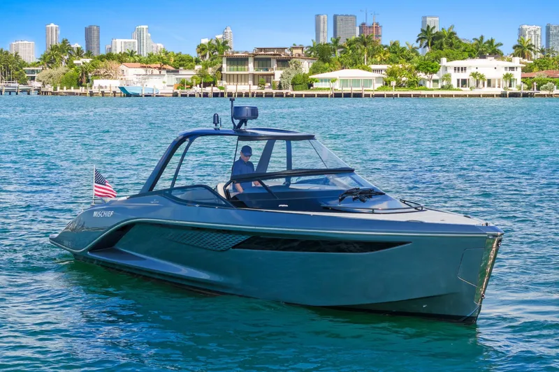 Mischief Yacht Photos Pics Luxury Princess R35 yacht cruising near city skyline, 2020 model.