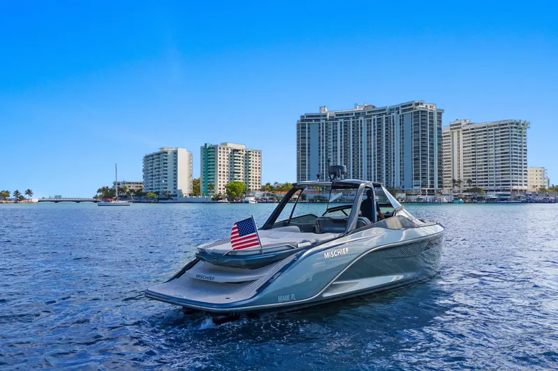 Mischief Yacht Photos Pics Luxury Princess R35 yacht on water, city skyline backdrop, 2020 model.