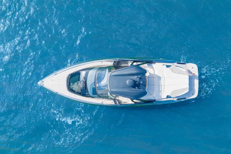 Mischief Yacht Photos Pics Aerial view of 2020 Princess R35 yacht cruising on clear blue water.