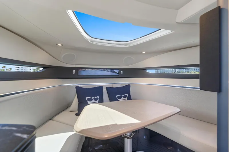 Mischief Yacht Photos Pics Luxurious interior of 2020 Princess R35 yacht with skylight and elegant seating area.