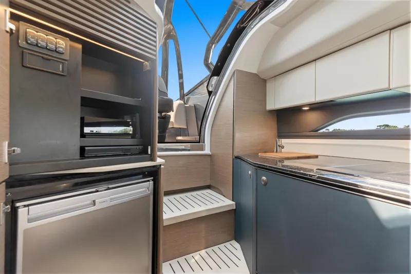 Mischief Yacht Photos Pics Modern kitchen interior of 2020 Princess R35 yacht, featuring sleek cabinetry and appliances.