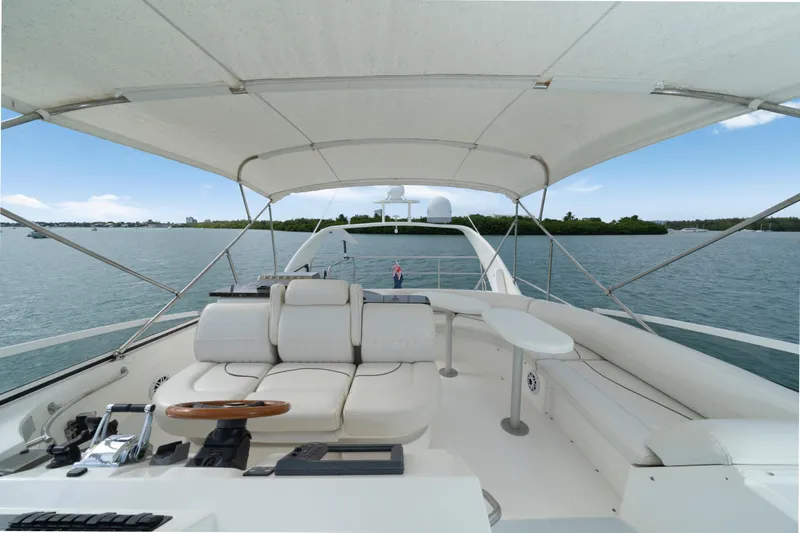  Yacht Photos Pics 2001 Cruisers Yachts 5000 Sedan Sport, spacious deck with seating, canopy, and scenic water view.