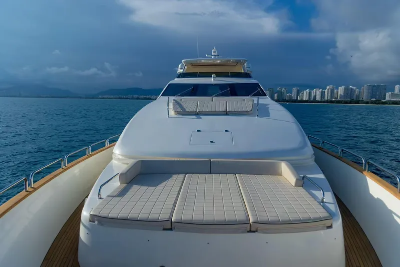  Yacht Photos Pics Luxurious 2010 Azimut 105 yacht cruising near city skyline under cloudy skies.