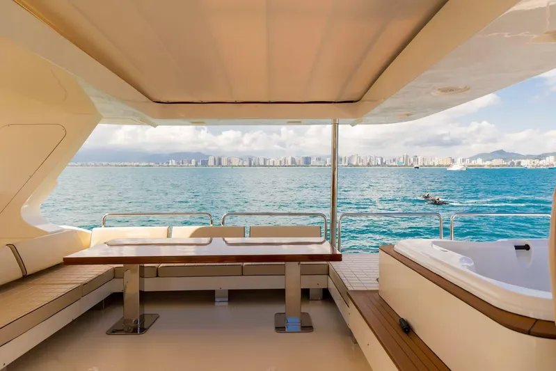  Yacht Photos Pics Luxurious 2010 Azimut 105 yacht deck with seating, table, and ocean view.