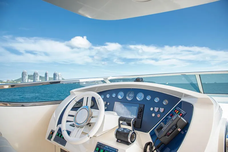  Yacht Photos Pics Cockpit view of 2010 Azimut 105 yacht with ocean and city skyline.