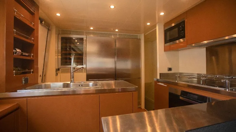  Yacht Photos Pics Luxurious kitchen interior on a 2010 Azimut 105 yacht, featuring modern appliances and sleek design.