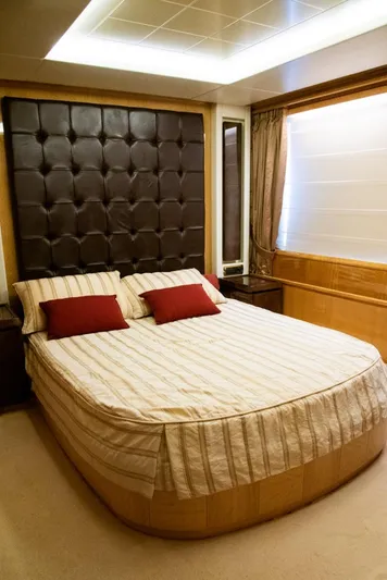  Yacht Photos Pics Luxurious bedroom interior on a 2010 Azimut 105 yacht, featuring elegant bedding and decor.