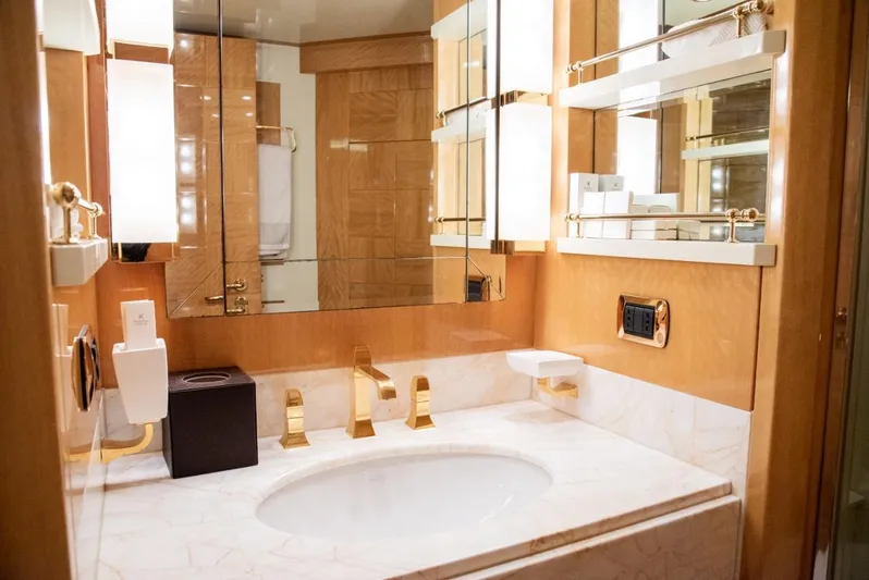  Yacht Photos Pics Luxurious bathroom with marble sink and gold fixtures on Azimut 105 yacht, 2010 model.